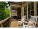 Inviting porch with outdoor dining set and comfortable rocking chairs at 385 Windy Pines Trl, Roswell, GA 30075