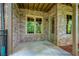 Covered patio shows the brick facade of the townhome with windows and access to the backyard at 385 Windy Pines Trl, Roswell, GA 30075