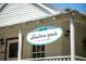 The Downtown Pooch, a charming pet boutique with a classic white exterior at 385 Windy Pines Trl, Roswell, GA 30075