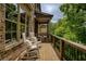 Relaxing porch with rocking chairs, wood flooring, and brick exterior at 385 Windy Pines Trl, Roswell, GA 30075
