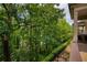 Lush greenery is viewed from the porch of this home at 385 Windy Pines Trl, Roswell, GA 30075