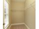 Small walk-in closet provides extra storage space with simple, functional shelving at 385 Windy Pines Trl, Roswell, GA 30075