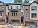 Newly constructed brick townhomes featuring open garage space and large window views at 4 Rock Park Way # 14, Tucker, GA 30084