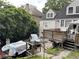 Exterior of home with wooden deck, a parked car, and mature trees at 55 Beverly Ne Rd, Atlanta, GA 30309
