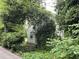 Side of a white house covered in ivy and surrounded by lush landscaping at 55 Beverly Ne Rd, Atlanta, GA 30309