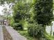 Gated entrance to a property with mature trees and lush landscaping at 55 Beverly Ne Rd, Atlanta, GA 30309