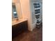 This bathroom has a dark vanity, white tile, and a tub behind a striped curtain at 6449 Pinebark Way, Morrow, GA 30260