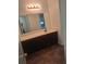 Bathroom with a large mirror and dark cabinets under a white countertop basin at 6449 Pinebark Way, Morrow, GA 30260