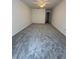 A spacious bedroom features plush gray carpeting, neutral walls, and a ceiling fan at 6449 Pinebark Way, Morrow, GA 30260