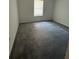 Neutral bedroom showcasing a serene space with new carpeting and a large window at 6449 Pinebark Way, Morrow, GA 30260