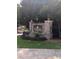 Stone monument sign at Northridge Condominiums entrance with colorful flower bed and wrought iron fencing at 6449 Pinebark Way, Morrow, GA 30260