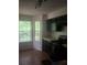 Traditional kitchen featuring black appliances, tile floors, and natural light from the adjacent window at 6449 Pinebark Way, Morrow, GA 30260