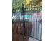 View of community pool behind black metal gate with 'pool hours' and 'pool closed' signs at 6449 Pinebark Way, Morrow, GA 30260