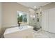 Bright bathroom with a soaking tub, large window and walk-in glass shower at 1330 Adams Sw Dr, Atlanta, GA 30311