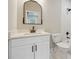 Bathroom featuring a white vanity, marble countertops and backsplash, and a decorative mirror above the sink at 1330 Adams Sw Dr, Atlanta, GA 30311
