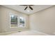 Cozy bedroom featuring neutral paint, carpet, large windows offering ample natural light, and a ceiling fan at 1330 Adams Sw Dr, Atlanta, GA 30311