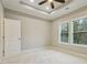 Bedroom with carpet flooring, natural light from windows, and a ceiling fan with tray ceiling at 1330 Adams Sw Dr, Atlanta, GA 30311