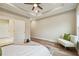 Bedroom featuring hardwood floors, a modern white settee, and natural light from multiple windows at 1330 Adams Sw Dr, Atlanta, GA 30311