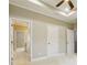 Bedroom with carpet floors, neutral walls, and white trim, showcasing open doorway to adjacent rooms at 1330 Adams Sw Dr, Atlanta, GA 30311