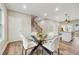 Elegant dining room with a glass-top table, modern chairs, and contemporary lighting fixtures at 1330 Adams Sw Dr, Atlanta, GA 30311