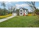 Inviting two-story home with a lush green lawn, white siding, and complementary black trim details at 1330 Adams Sw Dr, Atlanta, GA 30311