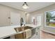 Kitchen features a deep stainless sink, quartz countertops, modern faucet, and a view of the outdoor living space at 1330 Adams Sw Dr, Atlanta, GA 30311