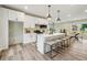 Updated kitchen showcasing stainless steel appliances, an island with seating, and modern finishes with hardwood floors at 1330 Adams Sw Dr, Atlanta, GA 30311