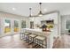 Modern kitchen featuring an island with barstool seating, stainless steel appliances, and hardwood flooring at 1330 Adams Sw Dr, Atlanta, GA 30311