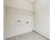 A compact laundry room with tile flooring and shelving at 1330 Adams Sw Dr, Atlanta, GA 30311