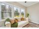 Bright living room featuring a stylish sofa, throw blanket, pillows, and a large window overlooking a scenic view at 1330 Adams Sw Dr, Atlanta, GA 30311