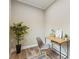 Cozy office nook featuring a modern desk, stylish chair, wood floors, and a decorative houseplant at 1330 Adams Sw Dr, Atlanta, GA 30311