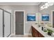 Well-lit bathroom with a glass-enclosed shower and wood vanity with double sinks at 1628 Briarcliff Ne Rd # 15, Atlanta, GA 30306