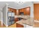 Well-equipped kitchen featuring stainless steel appliances, granite countertops, and wood cabinetry at 1628 Briarcliff Ne Rd # 15, Atlanta, GA 30306