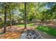 Landscaped backyard features a stone fire pit and wooden deck, perfect for outdoor gatherings at 2705 Osborne Ne Rd, Brookhaven, GA 30319