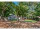 Large backyard with grass and treed area, offering privacy and space at 2705 Osborne Ne Rd, Brookhaven, GA 30319