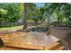 Beautiful backyard showcasing a wood deck and a stone fire pit area with retaining wall at 2705 Osborne Ne Rd, Brookhaven, GA 30319