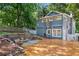 Backyard featuring fire pit, retaining wall, deck, and fenced yard at 2705 Osborne Ne Rd, Brookhaven, GA 30319