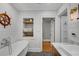 Bathroom features built in shelving for towels and decor with a freestanding soaking tub and bright fixtures at 2705 Osborne Ne Rd, Brookhaven, GA 30319