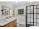 Bathroom with marble top vanity, shiplap walls, shower, and sleek fixtures at 2705 Osborne Ne Rd, Brookhaven, GA 30319