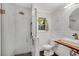 Modern bathroom with glass shower, shiplap walls, and wood vanity with vessel sink at 2705 Osborne Ne Rd, Brookhaven, GA 30319