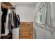 Well-organized walk-in closet with clothes rack, shelving, drawers, and a window providing natural light at 2705 Osborne Ne Rd, Brookhaven, GA 30319