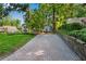 Paver driveway leads to a beautiful home, surrounded by mature trees and lush landscaping at 2705 Osborne Ne Rd, Brookhaven, GA 30319