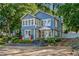 Charming two-story home boasts a covered porch, white trim, and a well-manicured front yard at 2705 Osborne Ne Rd, Brookhaven, GA 30319