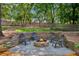 Inviting backyard fire pit surrounded by a stone retaining wall and wood chairs at 2705 Osborne Ne Rd, Brookhaven, GA 30319