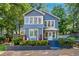 Charming blue two-story home with a landscaped front yard and inviting entryway, perfect for a Gathering at 2705 Osborne Ne Rd, Brookhaven, GA 30319