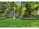 Expansive front yard with mature trees and a well-manicured lawn at 2705 Osborne Ne Rd, Brookhaven, GA 30319