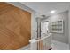 Upstairs hallway with white railing and eye-catching wood paneled wall at 2705 Osborne Ne Rd, Brookhaven, GA 30319