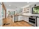 Modern kitchen with stainless steel appliances, white cabinetry, and a sleek black countertop at 2705 Osborne Ne Rd, Brookhaven, GA 30319