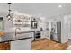 Bright kitchen with stainless steel appliances, modern lighting, and a sleek black countertop at 2705 Osborne Ne Rd, Brookhaven, GA 30319