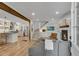 Open-concept living room featuring a fireplace, hardwood floors, and seamless flow into the modern kitchen at 2705 Osborne Ne Rd, Brookhaven, GA 30319